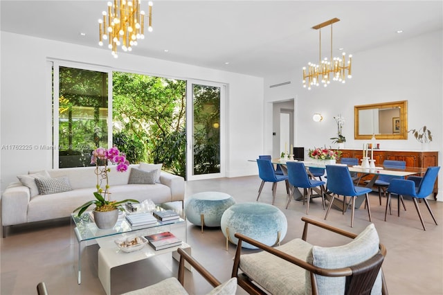 living room with finished concrete floors and an inviting chandelier