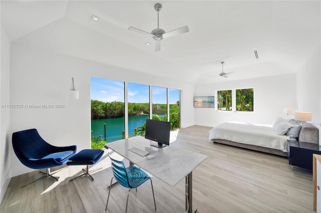 bedroom with baseboards, a ceiling fan, lofted ceiling, and light wood-style floors