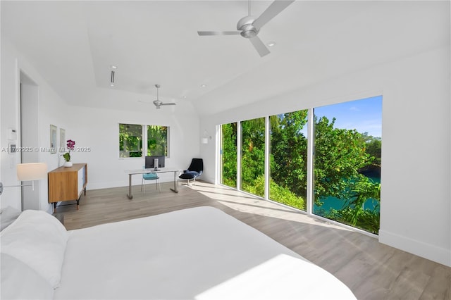 bedroom with ceiling fan, baseboards, and wood finished floors