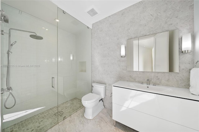 full bathroom featuring visible vents, toilet, marble finish floor, a shower stall, and vanity