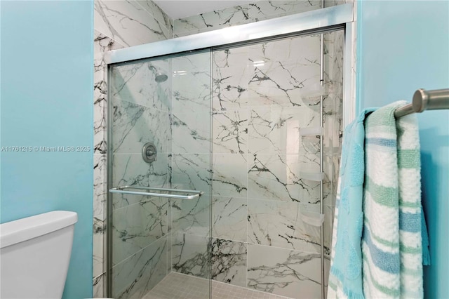 full bath with toilet and a marble finish shower