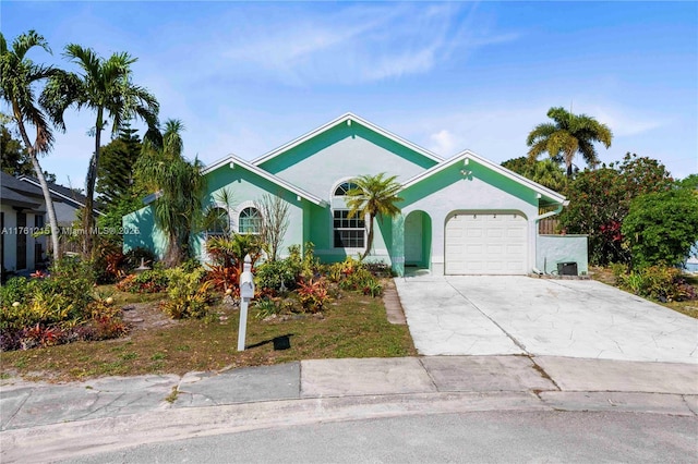 ranch-style house with stucco siding, concrete driveway, and a garage