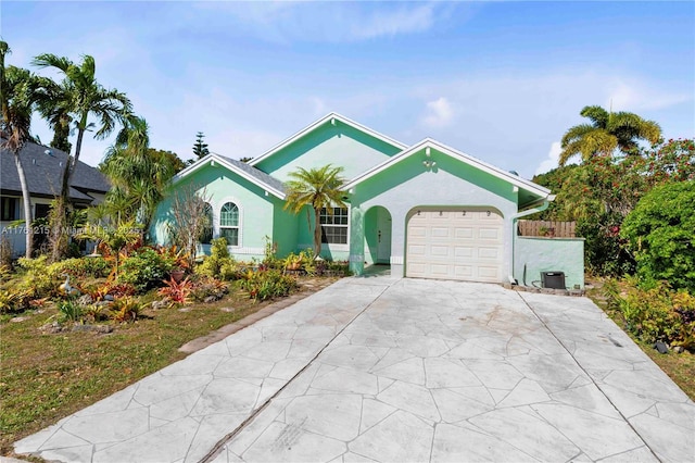 single story home featuring stucco siding, an attached garage, and concrete driveway