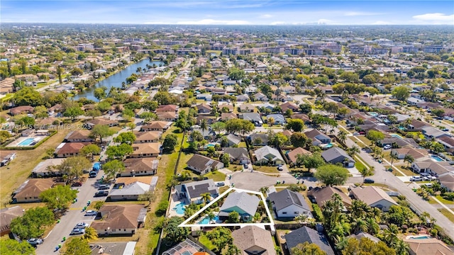 drone / aerial view featuring a residential view and a water view