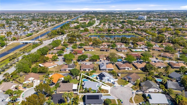 drone / aerial view with a water view and a residential view