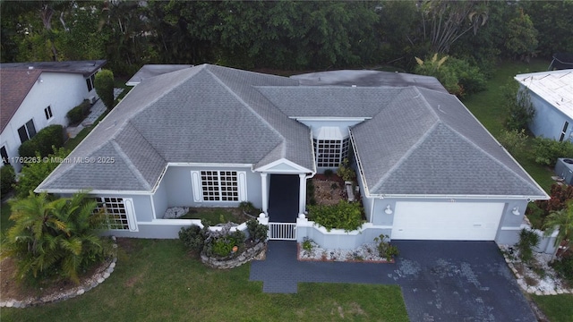 4511 Queen Palm Ln, Tamarac, FL 33319 - view of front of home with a garage, driveway, a front lawn, and stucco siding