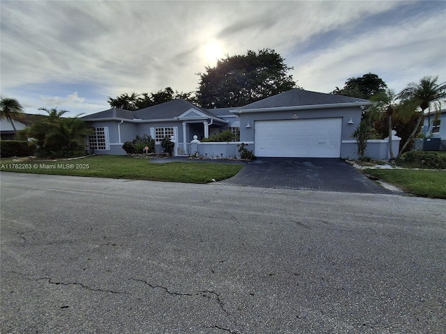 4511 Queen Palm Ln, Tamarac, FL 33319 - ranch-style home featuring driveway, stucco siding, and an attached garage