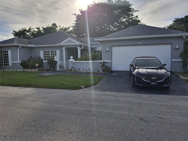 4511 Queen Palm Ln, Tamarac, FL 33319 - single story home with decorative driveway, stucco siding, a garage, and a front yard