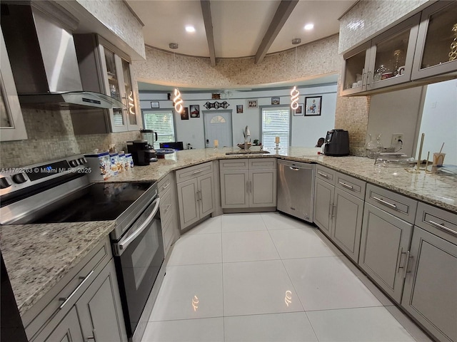4511 Queen Palm Ln, Tamarac, FL 33319 - kitchen with appliances with stainless steel finishes, wall chimney exhaust hood, a sink, a peninsula, and beamed ceiling