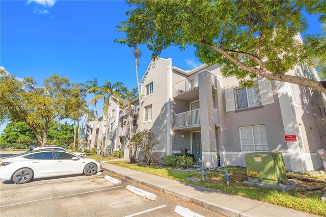 view of property featuring uncovered parking