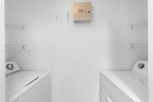 washroom featuring laundry area and washing machine and dryer