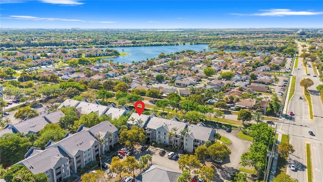 drone / aerial view with a water view and a residential view