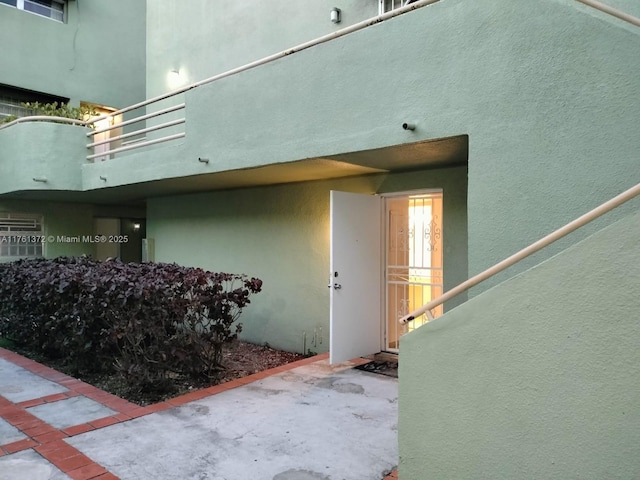 doorway to property featuring a patio and a balcony