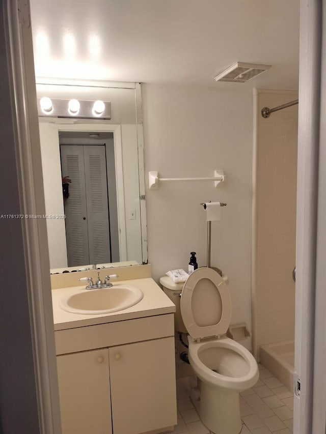 bathroom with vanity, visible vents, tile patterned flooring, walk in shower, and toilet