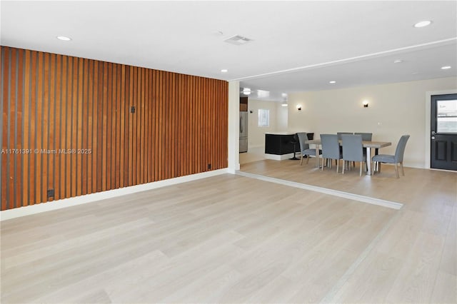 living area featuring light wood-style flooring, recessed lighting, and visible vents