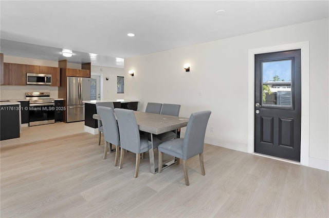 dining area with recessed lighting, baseboards, and light wood-style floors