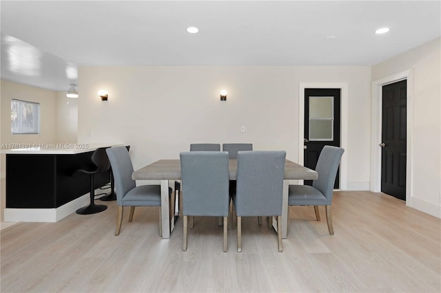 dining room with recessed lighting, baseboards, and wood finished floors