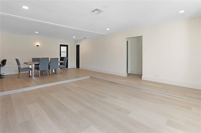 unfurnished living room with light wood finished floors, visible vents, recessed lighting, and baseboards