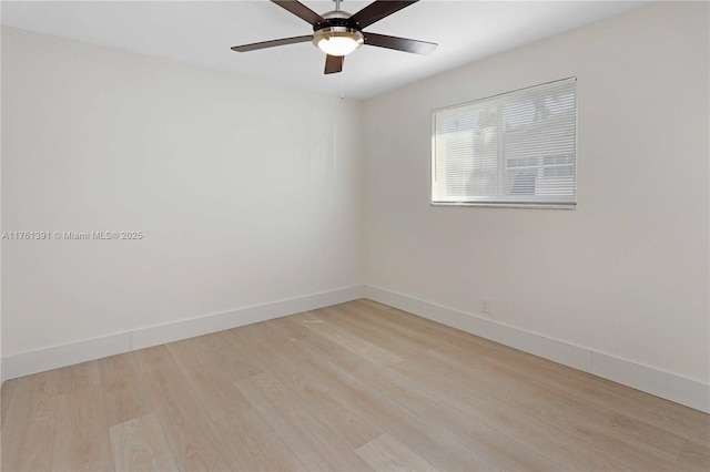 empty room with a ceiling fan, baseboards, and light wood finished floors