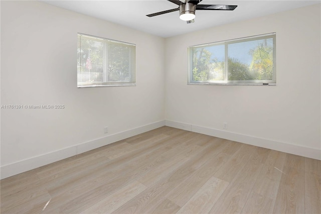 empty room with baseboards, light wood-style floors, and a ceiling fan