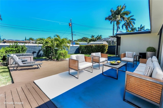 view of patio / terrace with a wooden deck, an outdoor hangout area, and a fenced backyard