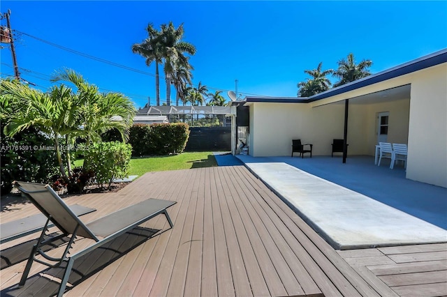 wooden terrace featuring a lawn