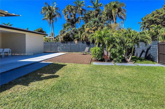 view of yard with a wooden deck and fence