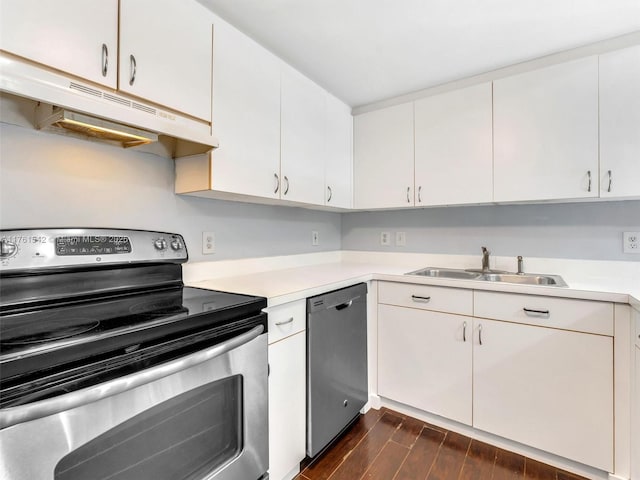 kitchen featuring under cabinet range hood, dark wood finished floors, light countertops, appliances with stainless steel finishes, and a sink