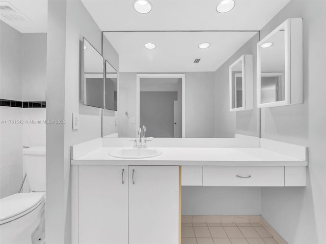 bathroom with visible vents, toilet, recessed lighting, tile patterned floors, and vanity