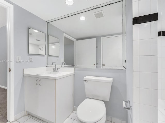 bathroom featuring visible vents, toilet, tile patterned flooring, baseboards, and vanity