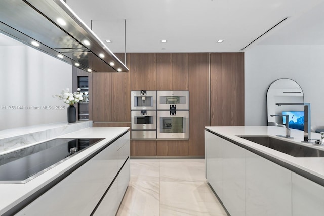 kitchen featuring a sink, modern cabinets, extractor fan, and black electric cooktop