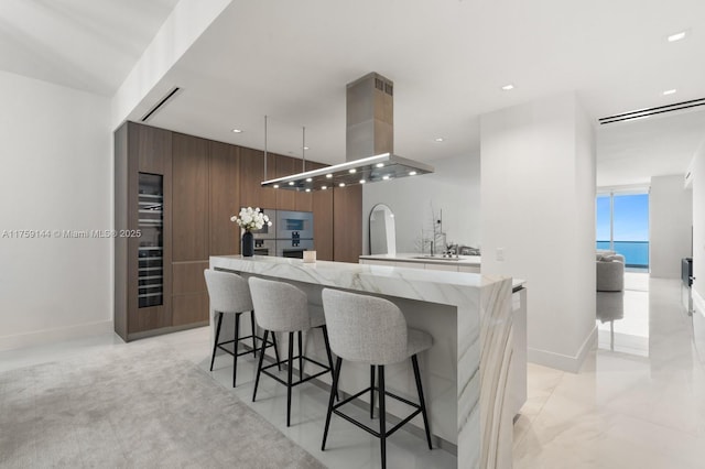 bar with island exhaust hood, expansive windows, baseboards, and recessed lighting