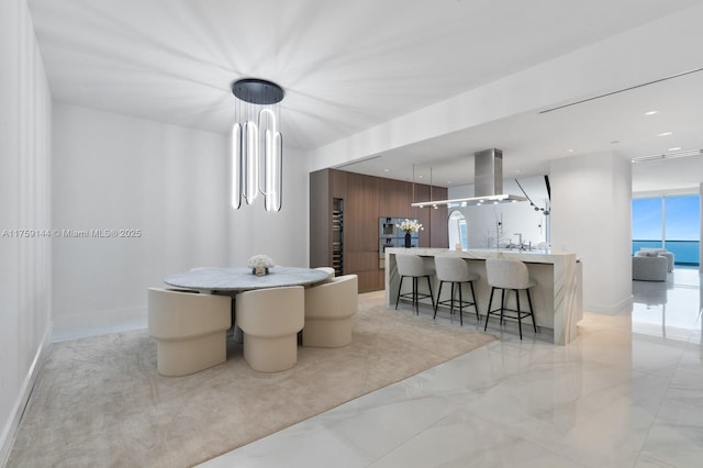 dining room featuring recessed lighting, marble finish floor, and baseboards