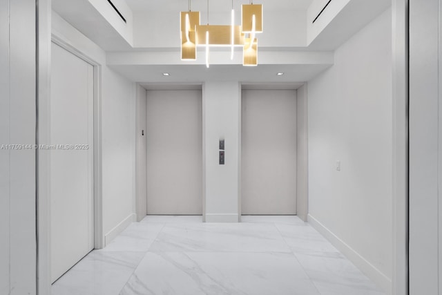 corridor featuring baseboards, elevator, and marble finish floor