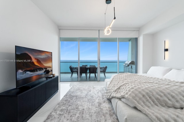 bedroom with a wall of windows and a water view