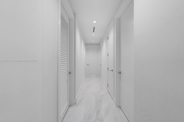 hall featuring marble finish floor