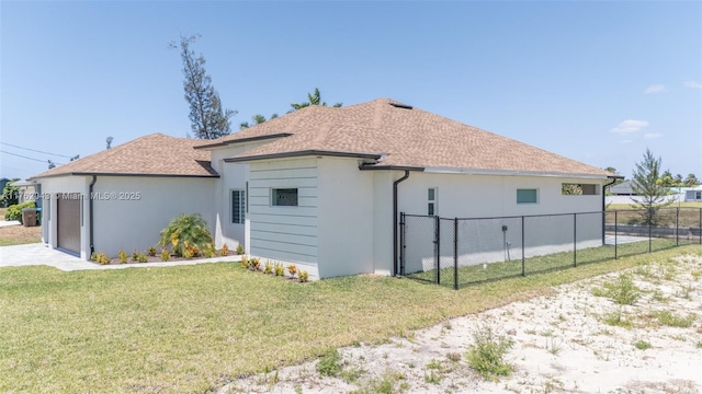 601SW 13th St, Cape Coral, FL 33991 - view of property exterior with stucco siding, a shingled roof, an attached garage, and a gate