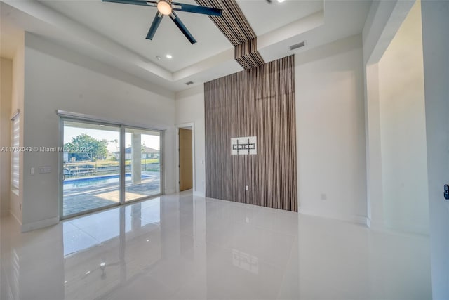 601SW 13th St, Cape Coral, FL 33991 - empty room with a towering ceiling, light tile patterned floors, a tray ceiling, ceiling fan, and recessed lighting