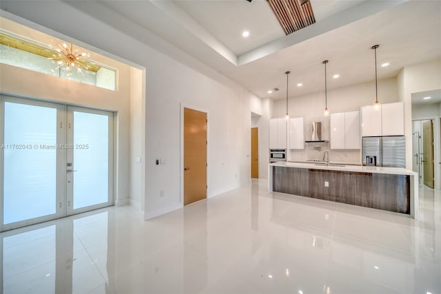 601SW 13th St, Cape Coral, FL 33991 - kitchen featuring appliances with stainless steel finishes, modern cabinets, wall chimney range hood, white cabinets, and a sink