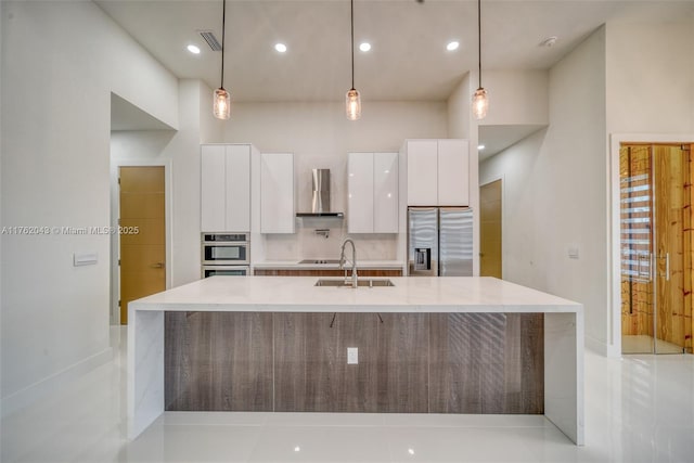 601SW 13th St, Cape Coral, FL 33991 - kitchen with stainless steel fridge, modern cabinets, wall chimney range hood, a sink, and white cabinetry
