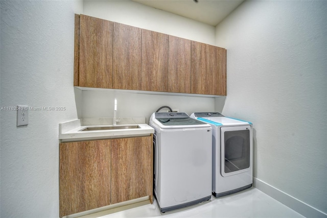 601SW 13th St, Cape Coral, FL 33991 - laundry area with cabinet space, washing machine and clothes dryer, a textured wall, and baseboards