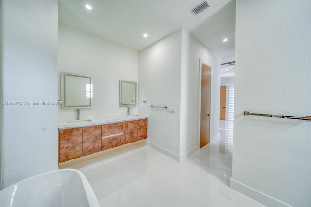 601SW 13th St, Cape Coral, FL 33991 - full bathroom featuring recessed lighting, a soaking tub, tile patterned flooring, and double vanity