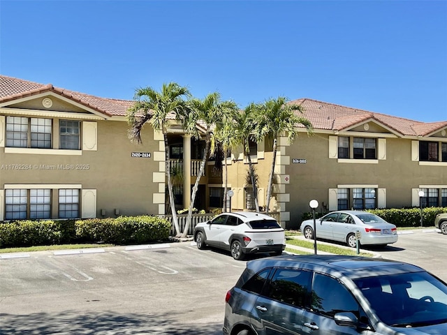 view of property featuring uncovered parking