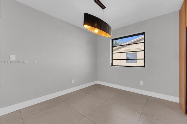 empty room featuring baseboards