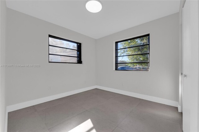 spare room featuring baseboards