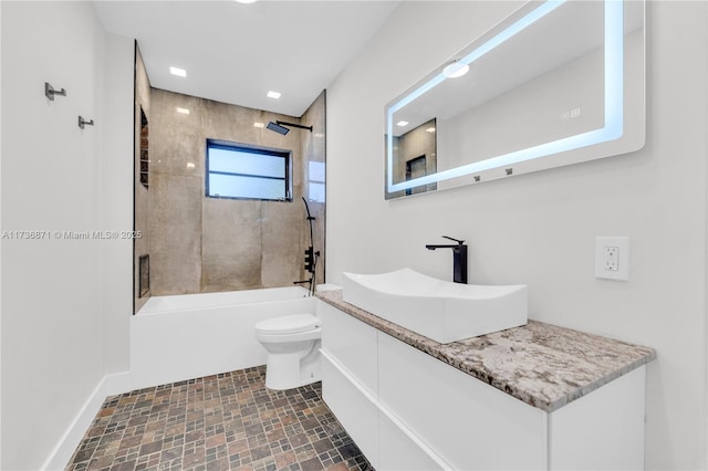 bathroom with vanity, shower / bathing tub combination, and toilet