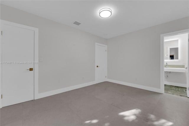 empty room featuring visible vents and baseboards