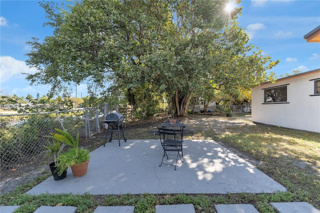 view of patio with a fenced backyard and a grill