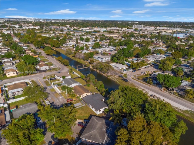 drone / aerial view featuring a residential view and a water view