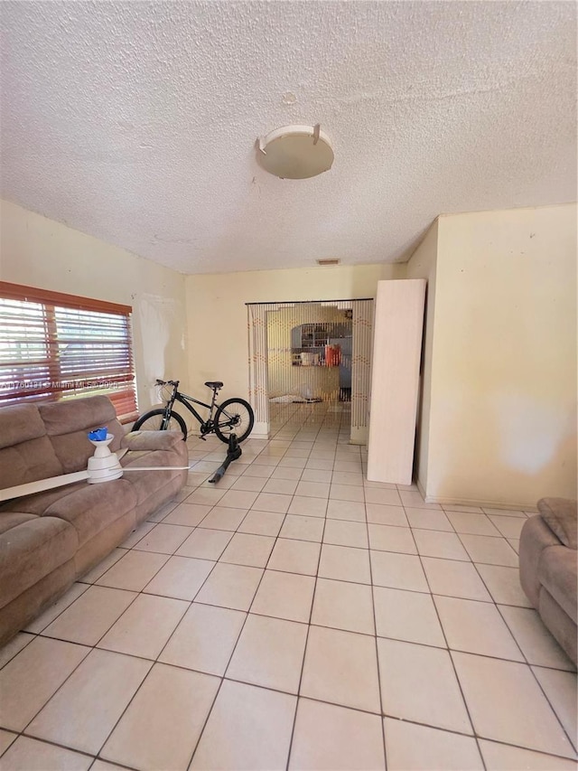 interior space with light tile patterned floors and a textured ceiling